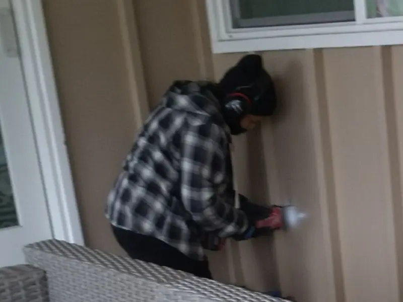 Professional electrician installing an exterior outlet in Sandy